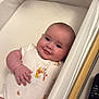 Heidi joined the competition — help win amazing prizes! baby, infant, onesie, winnie_the_pooh, bassinet, smiling, face, hand, remote_control, wood, fabric, cute, lying_down, cheeks, skin, child, toy_character, comfort, home, peaceful