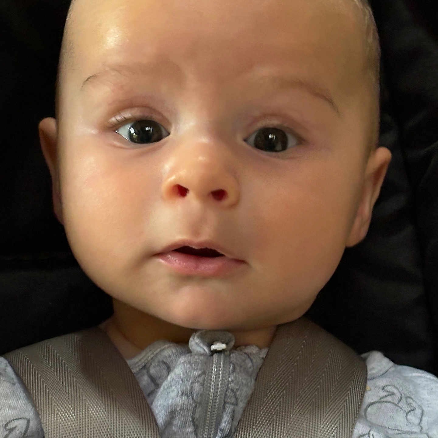Cassian is registered to the contest to win money with this photo: accessories, baby, belt, car, car_interior, carseat, clothing, coat, cushion, face, frown, head, homedecor, newborn, pants, person, photography, portrait, sad, seatbelt