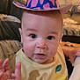 Maddox joined the competition — help win amazing prizes! baby, child, cowboy_hat, hat, indoor, face, hand, curious, person, clothing, highchair, expression, infant, eye_contact, skin, young_child, home, furniture, yellow_shirt, colorful