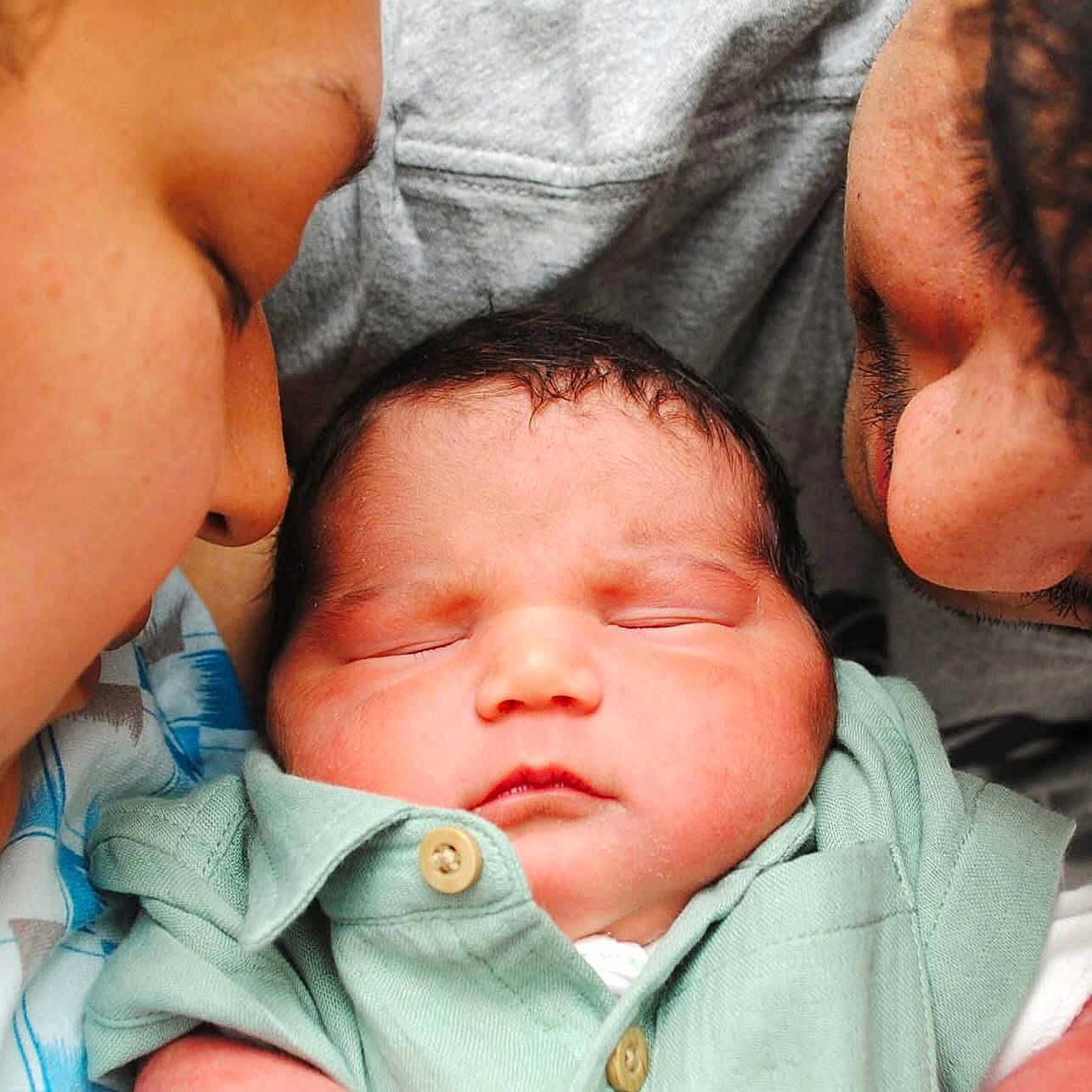 Jordan is registered to the contest to win money with this photo: accessories, adult, architecture, baby, building, earring, face, female, head, hospital, kissing, newborn, people, person, photography, portrait, quilt, romantic, sleeping, woman