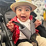 toddler, child, hat, stroller, smile, happy, sitting, clothing, red_shirt, beige_shorts, seatbelt, indoors, baby, cute, cheerful, face, person, portrait, expression, hat_brim