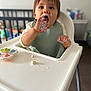 Livio participe au concours pour gagner de l'argent avec cette photo : baby, child, clothing, cream, cute, eating, face, feeding_time, food, hands, high_chair, indoor, messy, mouth_open, person, plastic, playful, seat, toddler, toy