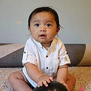 Arzen joined the competition — help win amazing prizes! baby, child, balloon, carpet, white_shirt, sitting, indoor, curious, hands, feet, face, expression, black_balloon, soft_lighting, home, floor, blanket, portrait, infant, cute