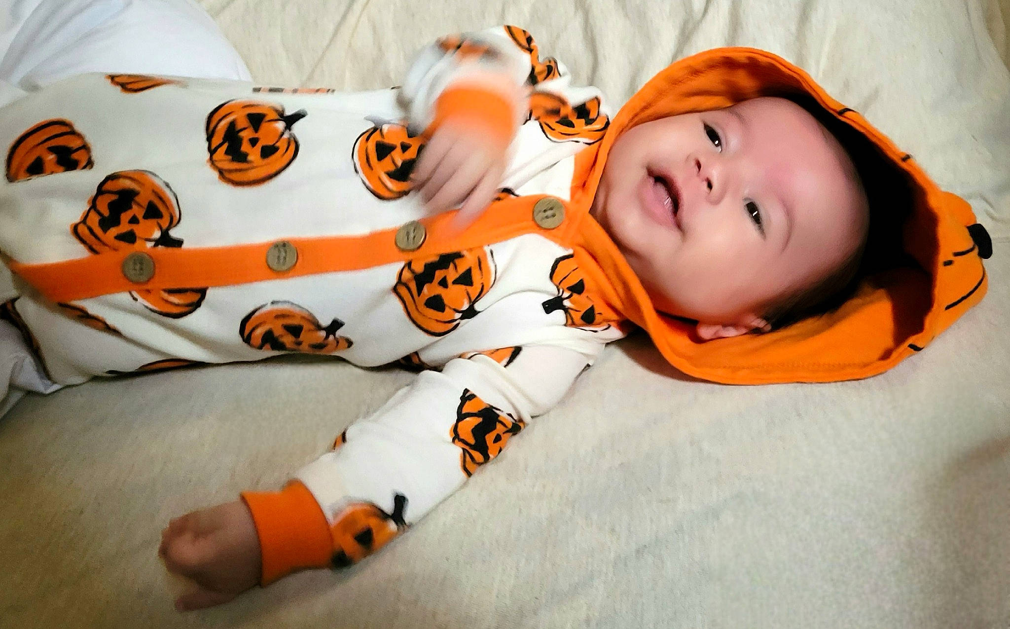 Joaquin is registered to the contest to win money with this photo: baby, baby_toddler_clothing, bedding, child, comfort, flooring, happy, linens, orange, pattern, person, pumpkin, room, sleeve, toddler