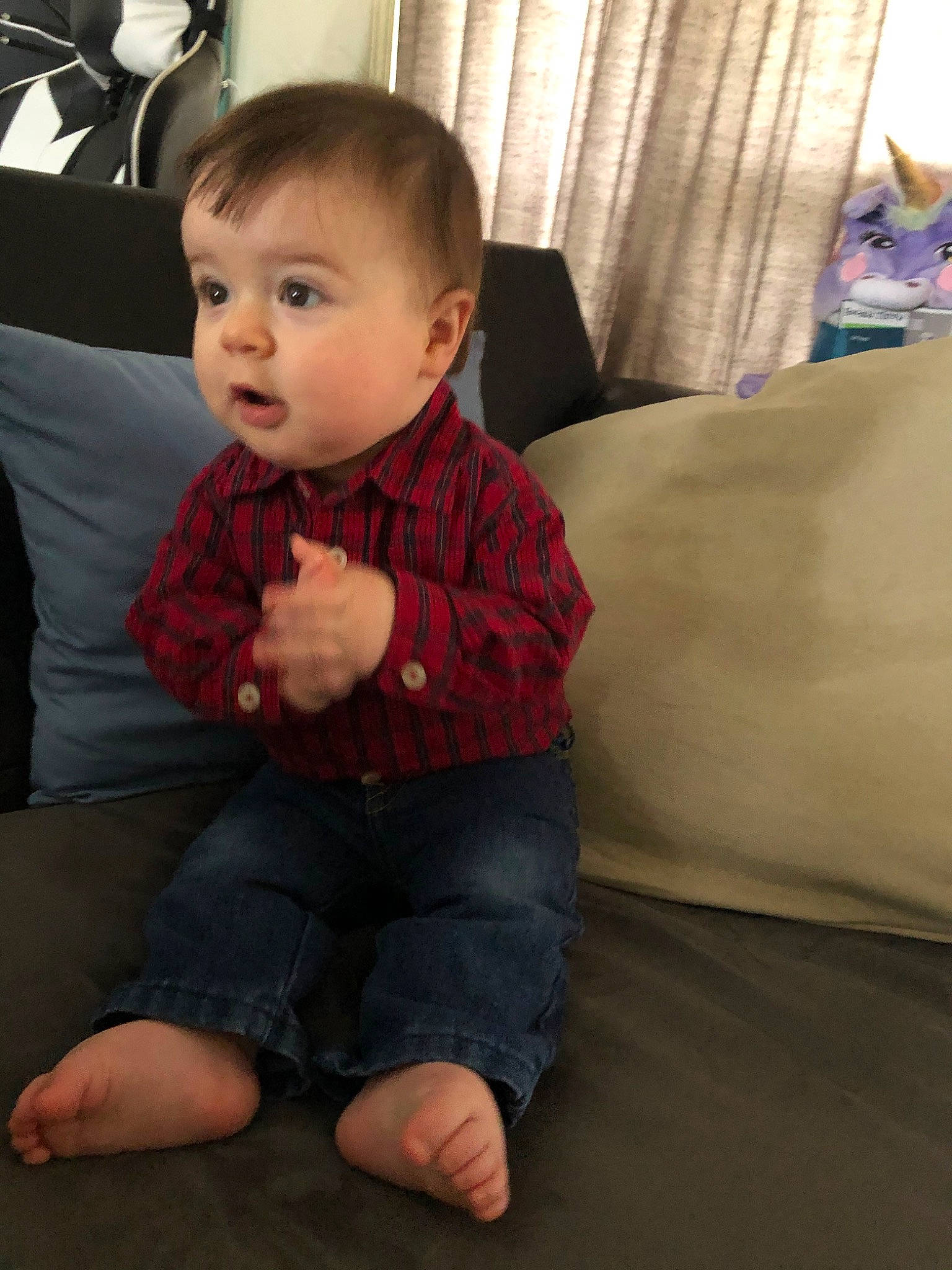 Clayton is registered to the contest to win money with this photo: arm, baby, cheek, child, chin, eye, face, floor, flooring, head, leg, outerwear, person, sitting, skin, standing, surprise, toddler