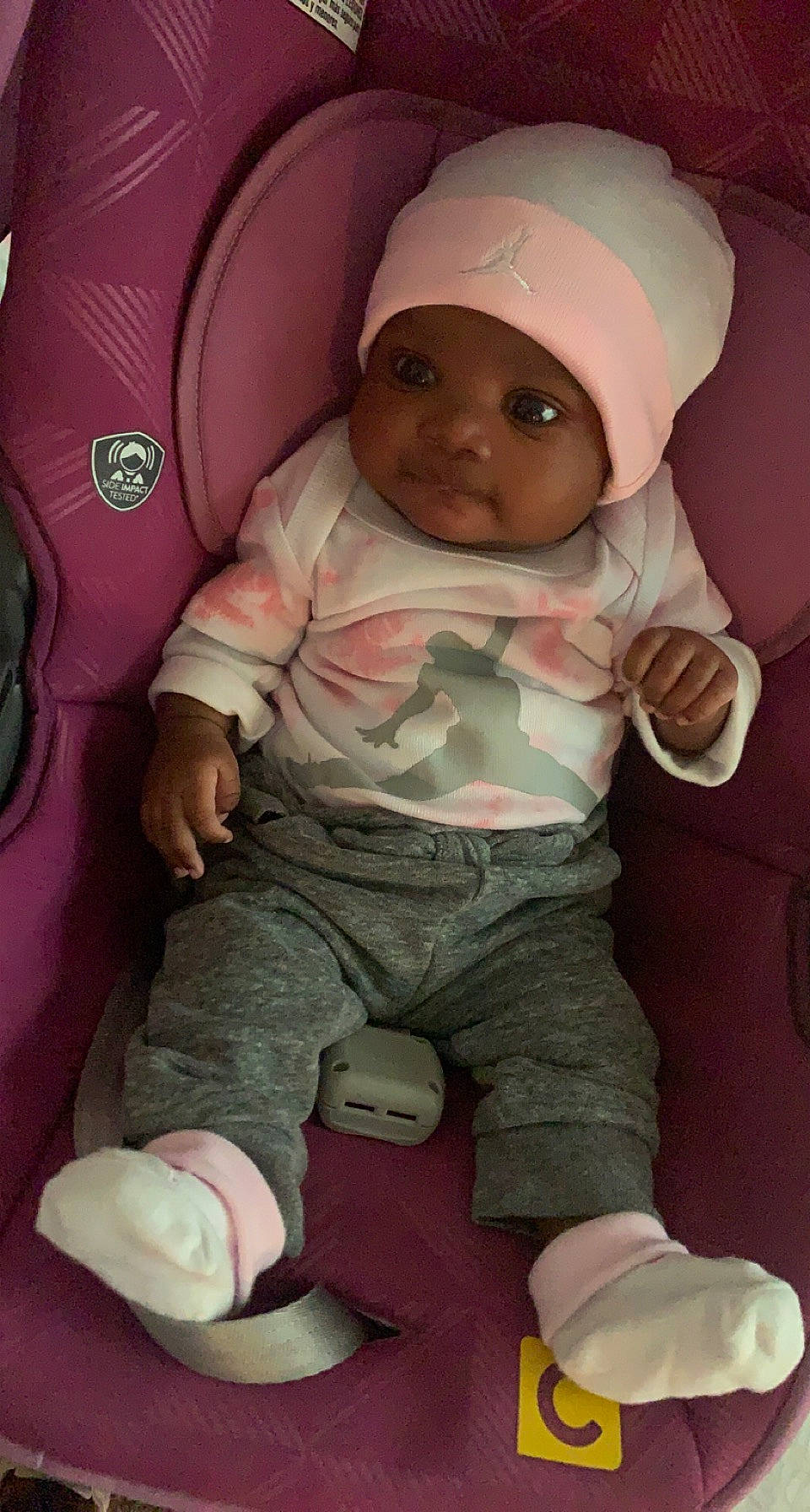 Dearra is registered to the contest to win money with this photo: baby, baby_carriage, baby_toddler_clothing, cap, car_seat, cheek, child, comfort, finger, headwear, human_body, mouth, nose, person, pink, sitting, skin, sleeve, thigh, thumb