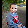Adrian joined the competition — help win amazing prizes! child, boy, smiling, portrait, outdoor, stool, sweatshirt, pants, cartoon, character, nature, greenery, blurred_background, casual_clothing, happy, young, seated, daylight, photography, park