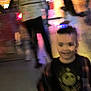 Adrian is registered to the contest to win money with this photo: child, blurry, indoor, people, smile, colorful, lights, party, person, crowd, background, shirt, hair, face, movement, dark, standing, casual, event, fun