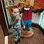 Adrian joined the competition — help win amazing prizes! background, camouflage_clothing, carpet, child, decor, footwear, glass_wall, hand, indoor, moose, motion_blur, number_one, person, play_area, red_shirt, reflection, snack, statue, toy, wooden_statue