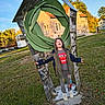 Adrian joined the competition — help win amazing prizes! child, playground, sculpture, outdoor, autumn, grass, trees, architecture, building, house, blue_sky, portrait, standing, arms_outstretched, hooded_jacket, striped_shirt, gray_pants, sneakers, play_area, daylight