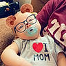 arm, baby, bear_ears_filter, brown_couch, casual_clothing, child, couch, cute, filter_effect, glasses_filter, hand, indoor, infant, love_mom, onesie, pacifier, person, portrait, relaxing, smile