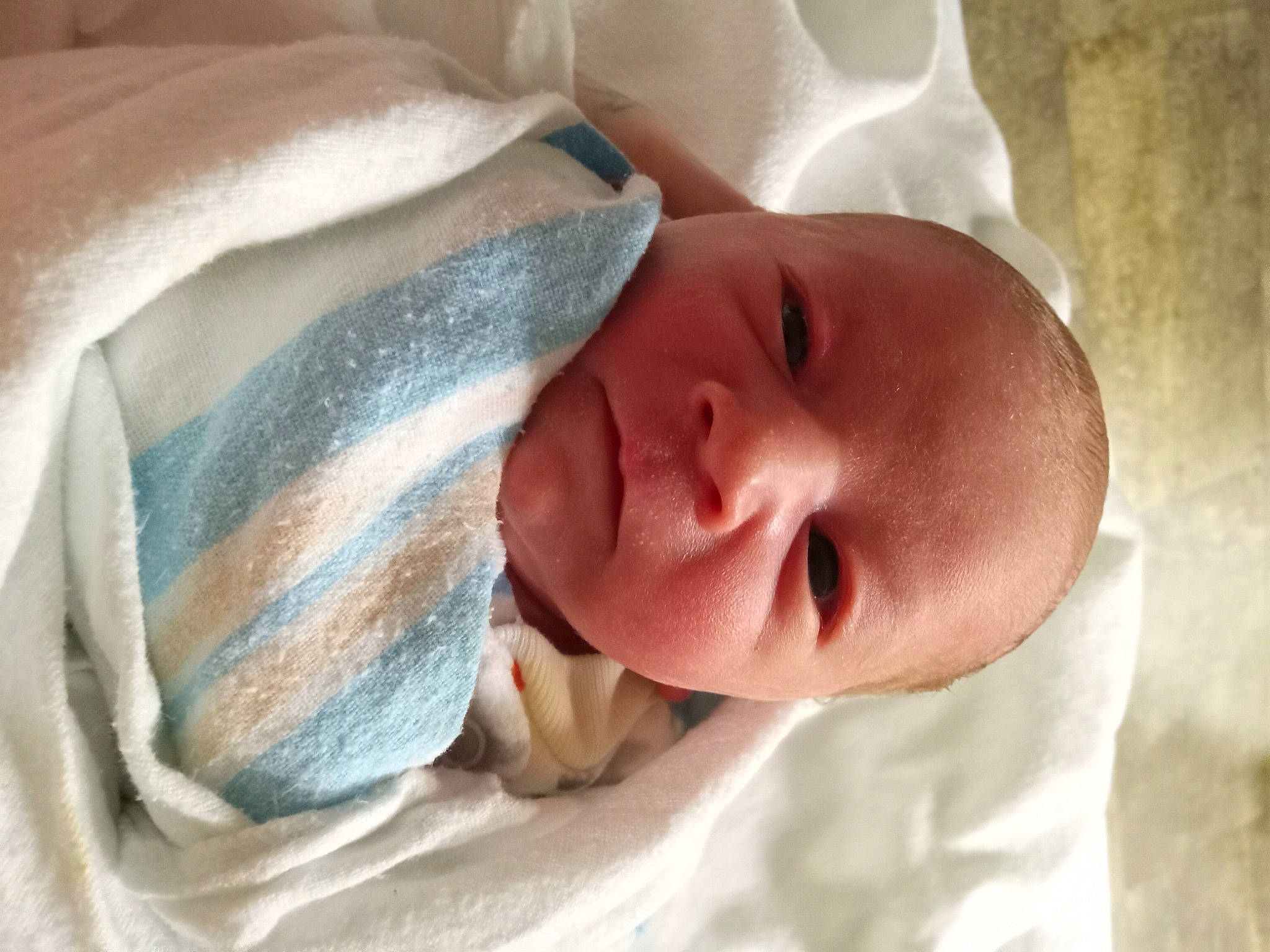 Atreyu is registered to the contest to win money with this photo: arm, baby, baby_products, bedtime, cheek, chin, comfort, ear, eye, eyebrow, hand, head, human_body, iris, linens, lip, nose, person, skin, smile