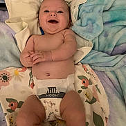 Gemma joined the competition — help win amazing prizes! baby, infant, smiling, diaper, blanket, floral_pattern, blue_blanket, laying_down, happy, cute, skin, hands, face, cheeks, newborn, comfort, soft, indoors, child, baby_girl