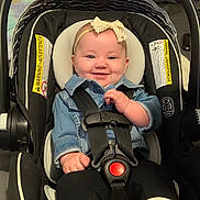 Gemma joined the competition — help win amazing prizes! baby, baby_boots, bow, car_seat, child, clothing, cute, denim_jacket, footwear, happy, headband, indoor, infant, person, portrait, safety, seatbelt, small_child, smiling, toddler