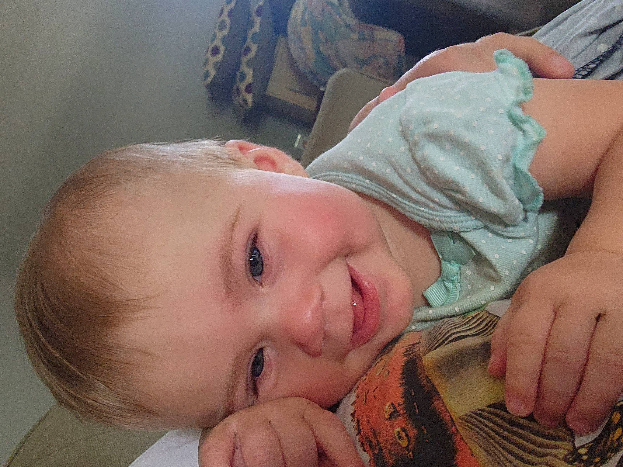 Ela is registered to the contest to win money with this photo: baby, baseball_glove, cheek, eye, eyebrow, eyelash, face, finger, gesture, grass, happy, hat, iris, joy, lip, mouth, nose, person, skin, smile