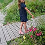Julia participe au concours pour gagner de l'argent avec cette photo : child, girl, dress, sandals, wooden_walkway, garden, flowers, greenery, plants, parking_garage, cars, people, outdoor, nature, smile, portrait, side_view, urban, daylight, casual_clothing