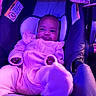 Nalani joined the competition — help win amazing prizes! baby, infant, car_seat, pink_clothing, smiling, face, child, indoor, seat, cozy, cute, portrait, soft_lighting, purple_light, apparel, person, young_child, baby_clothes, relaxing, comfortable