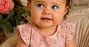 Nova is registered to the contest to win money with this photo: baby, child, girl, blue_eyes, pink_bow, pink_dress, floral_pattern, portrait, smiling, cute, sitting, chair, indoor, soft_lighting, flowers, decor, headband, happy, closeup, infant