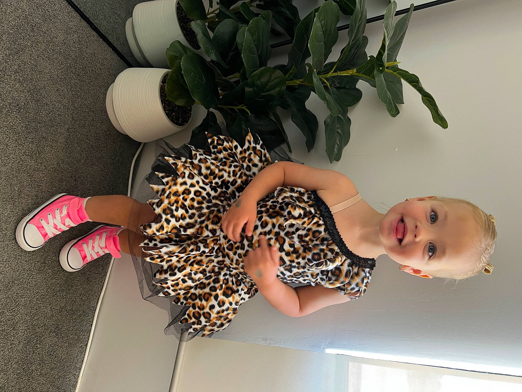 Ivy is registered to the contest to win money with this photo: arm, dress, elbow, fashion_design, fawn, green, hairstyle, happy, houseplant, human_body, human_leg, joy, knee, pattern, person, plant, sandal, smile, thigh, trunk