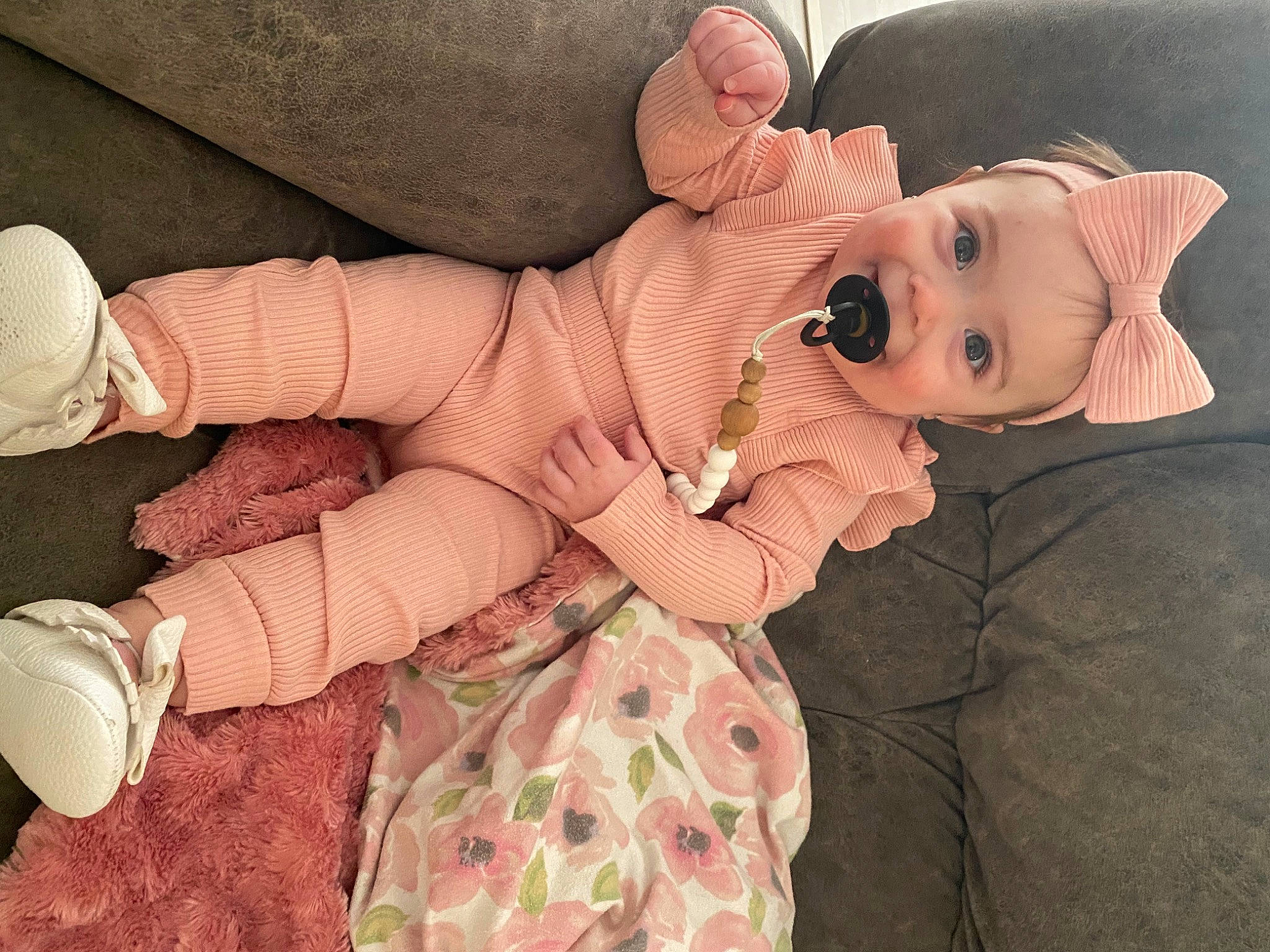 Holland is registered to the contest to win money with this photo: baby, baby_toddler_clothing, comfort, eye, finger, gesture, hand, hat, human_body, human_leg, knee, lip, person, pink, skin, textile, thigh, thumb, toddler, toy