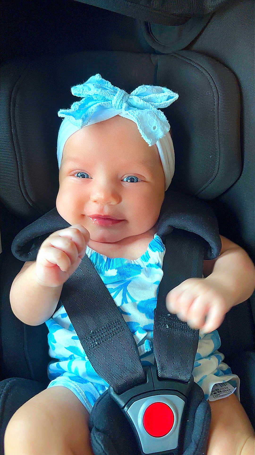 Star joined the competition — help win amazing prizes! baby, child, car_seat, smiling, blue_eyes, headband, bow, clothing, infant, seatbelt, cute, portrait, happy, sitting, young_child, closeup, safety, baby_girl, soft_lighting, indoor