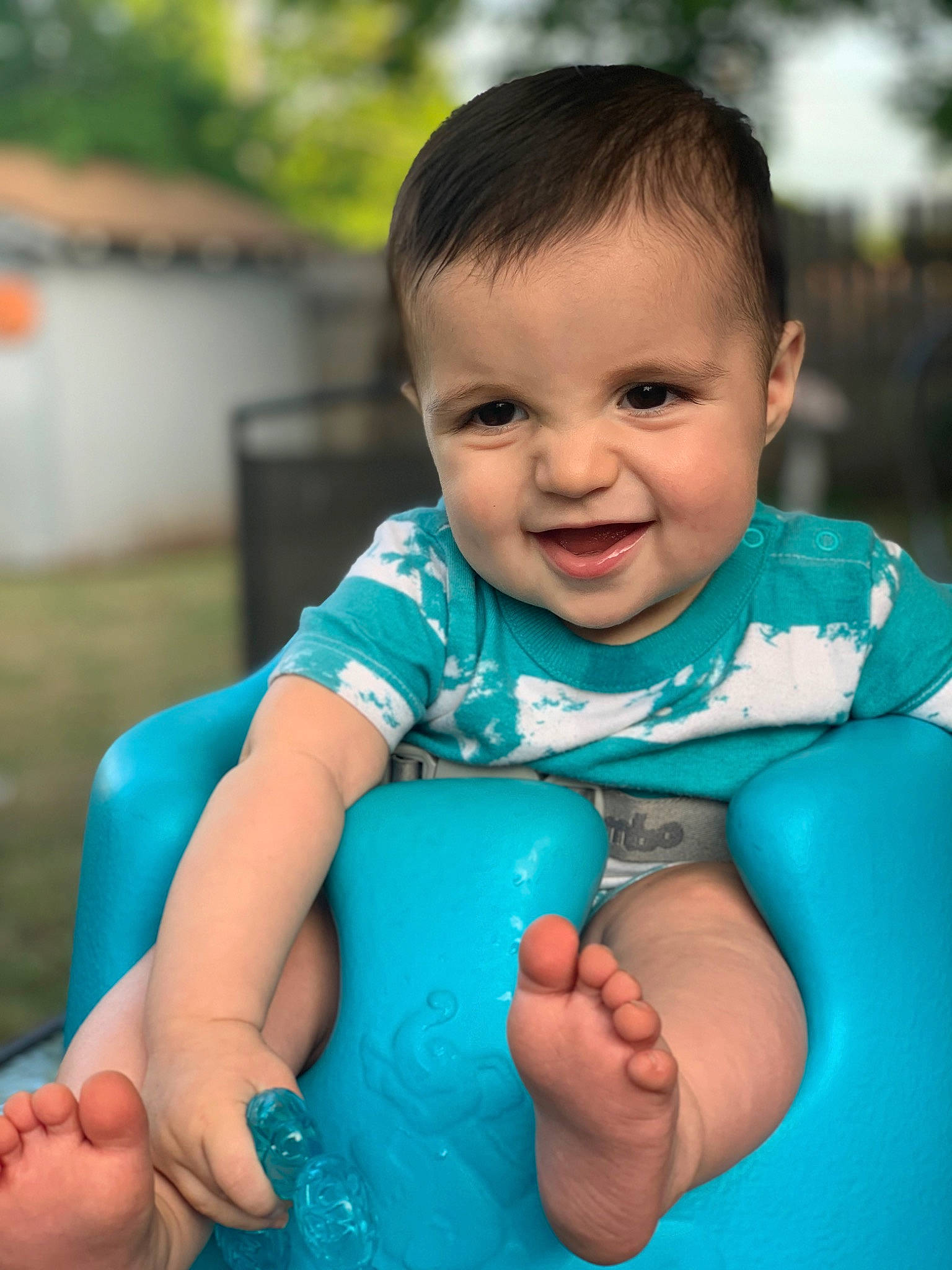 Azriel is registered to the contest to win money with this photo: aqua, azure, baby, baby_toddler_clothing, blue, chin, eye, facial_expression, finger, flash_photography, gesture, grass, hairstyle, hand, happy, iris, joy, leisure, person, skin