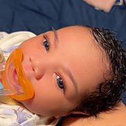 Remi is registered to the contest to win money with this photo: baby, infant, pacifier, curly_hair, close_up, blanket, sleeping, face, child, cute, soft_lighting, indoor, person, resting, newborn, comfort, toddler, skin, expression, head