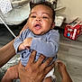Josiah joined the competition — help win amazing prizes! baby, child, infant, hands, tattoo, diaper, indoor, floor, clothing, person, expression, furniture, packaging, diapers, baby_supplies, foot, holding, curly_hair, skin, casual