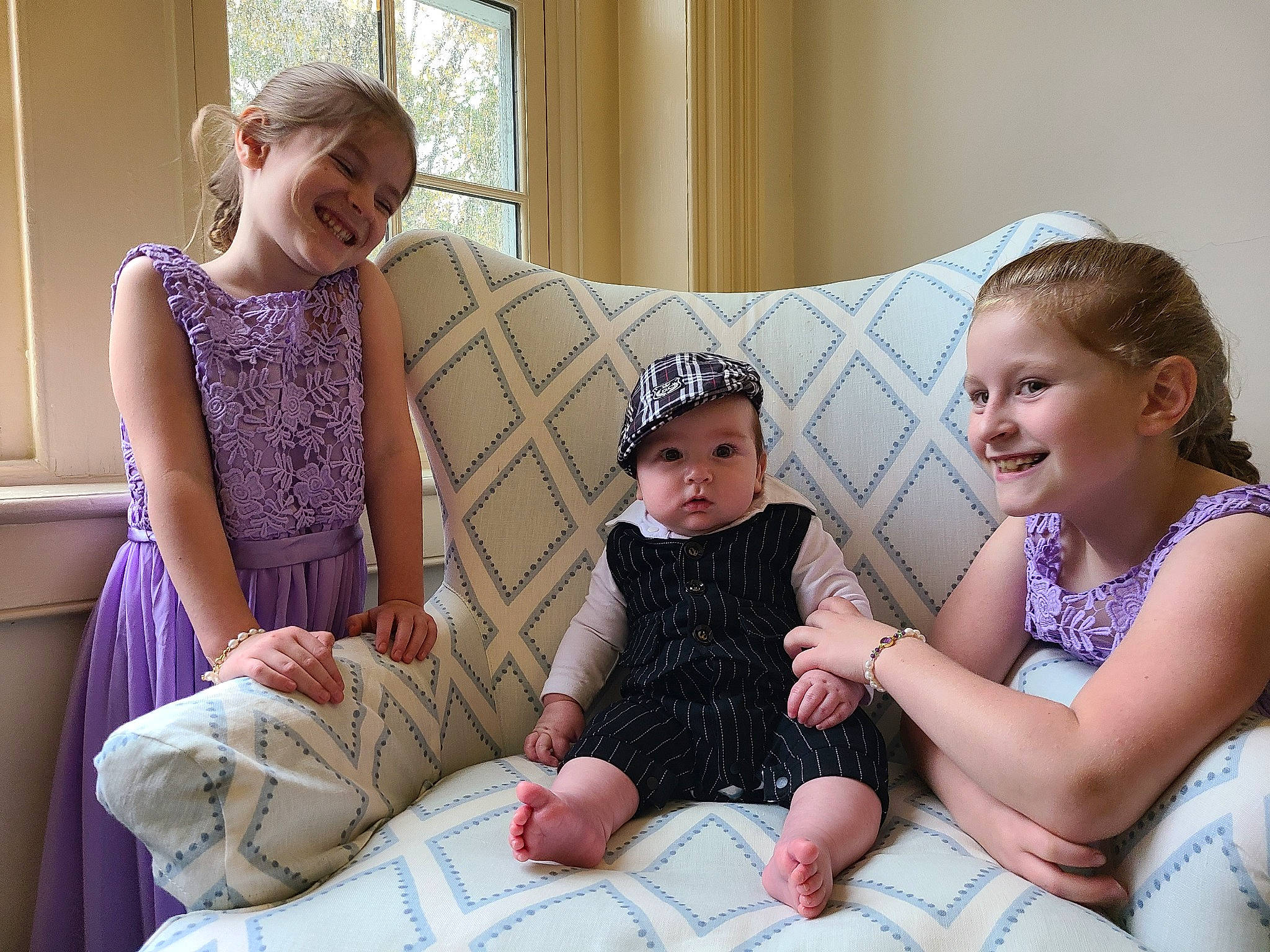 Alistair joined the competition — help win amazing prizes! arm, baby, baby_toddler_clothing, comfort, couch, face, facial_expression, happy, head, headwear, joy, lap, leg, people, person, photograph, pink, playing_with_kids, purple, skin