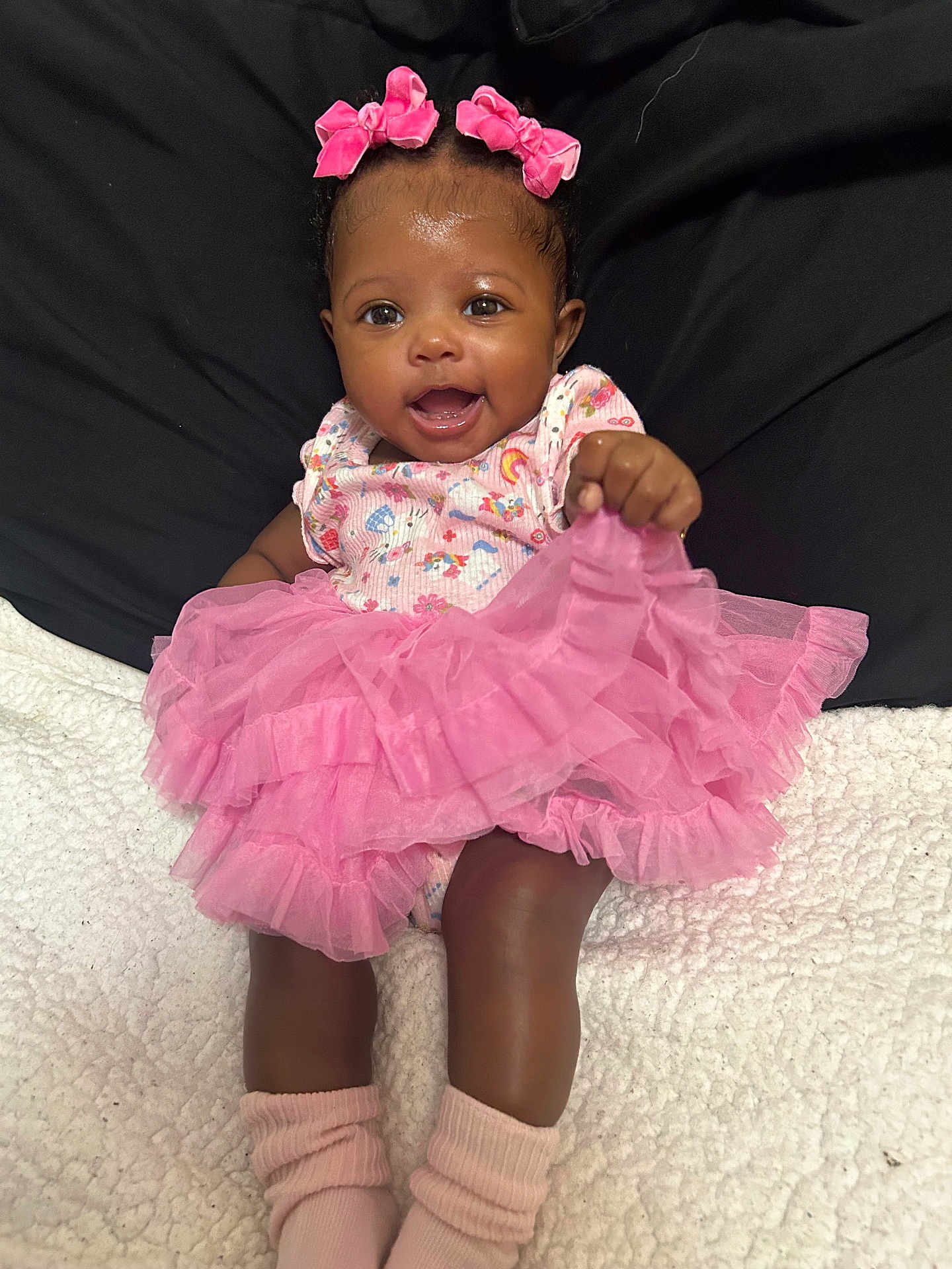 Zahria is registered to the contest to win money with this photo: baby, infant, girl, pink_bows, tutu, pink_tutu, socks, smiling, happy, cute, cheerful, clothing, portrait, indoors, child, cute_baby, fashion, baby_girl, playful, joyful