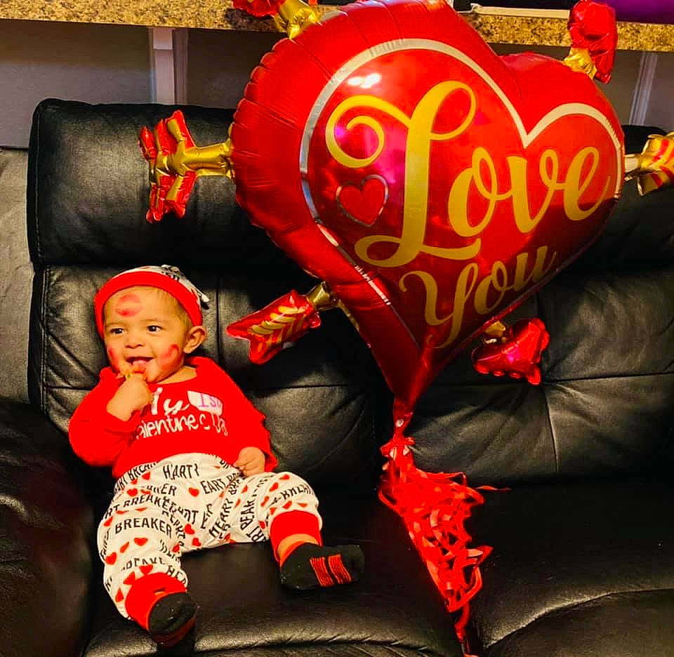 Issac is registered to the contest to win money with this photo: baby, baby_toddler_clothing, carmine, comfort, couch, event, flooring, fun, happy, holiday, lap, leisure, orange, person, photograph, red, room, sitting, snapshot, toddler