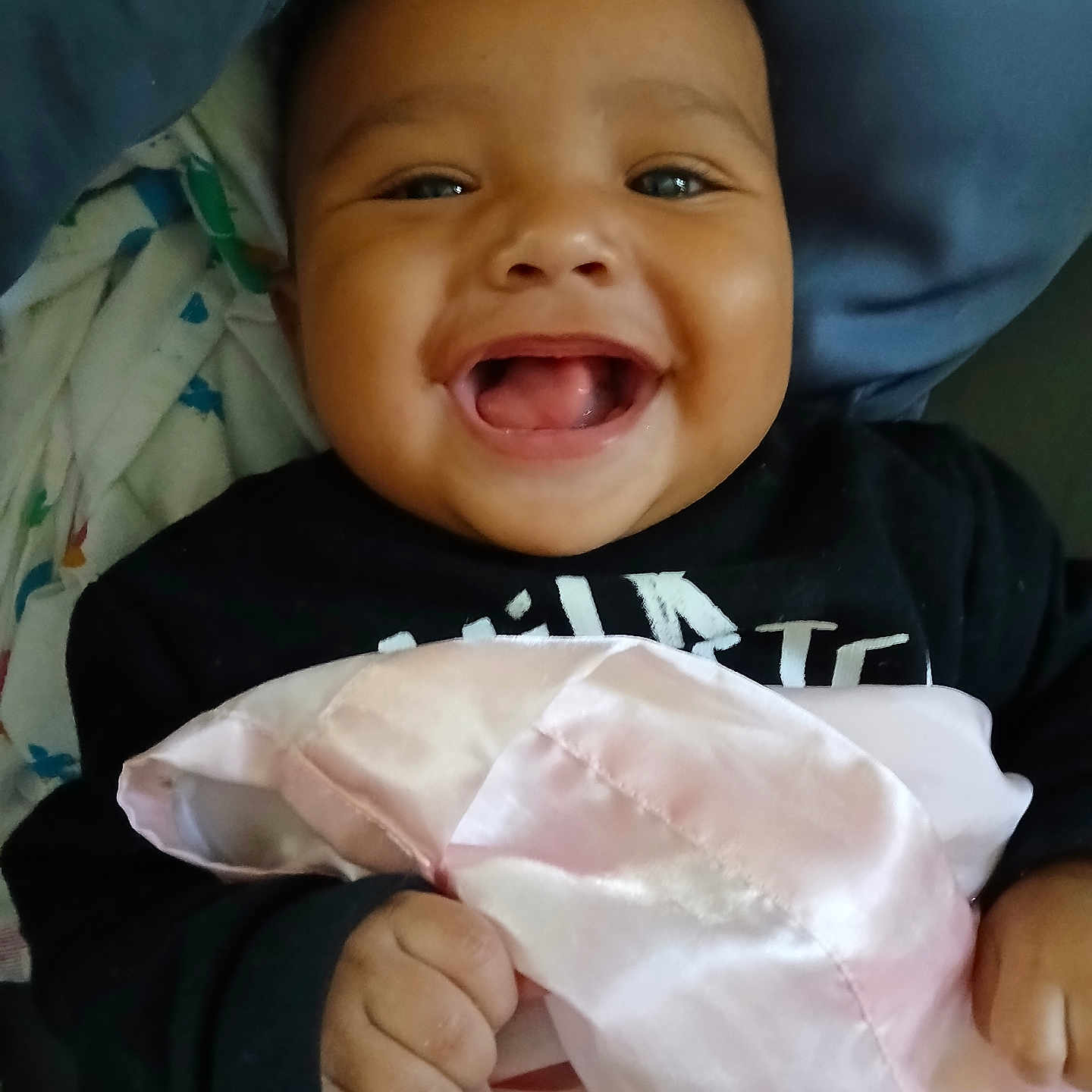 Kayvon is registered to the contest to win money with this photo: baby, bed, blanket, child, clothing, cozy, cute, fabric, face, hand, happy, holding, indoors, infant, person, pillow, portrait, skin, smiling, toddler