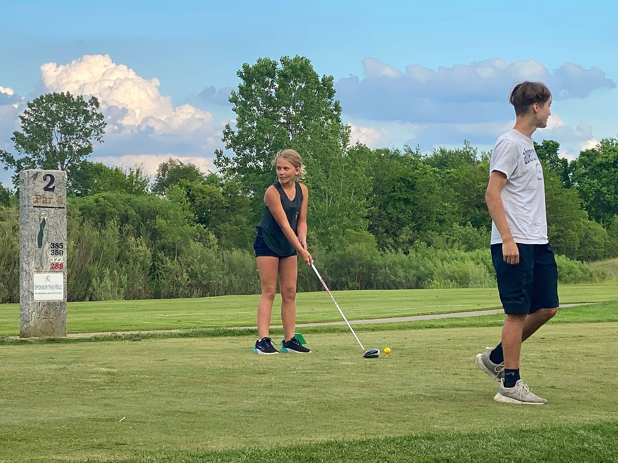 Melodie is registered to the contest to win money with this photo: cloud, golf, golf_club, golf_course, golf_equipment, golfer, grass, green, land_lot, leisure, match_play, person, plain, plant, precision_sports, professional_golfer, shorts, sky, sports_equipment, tree