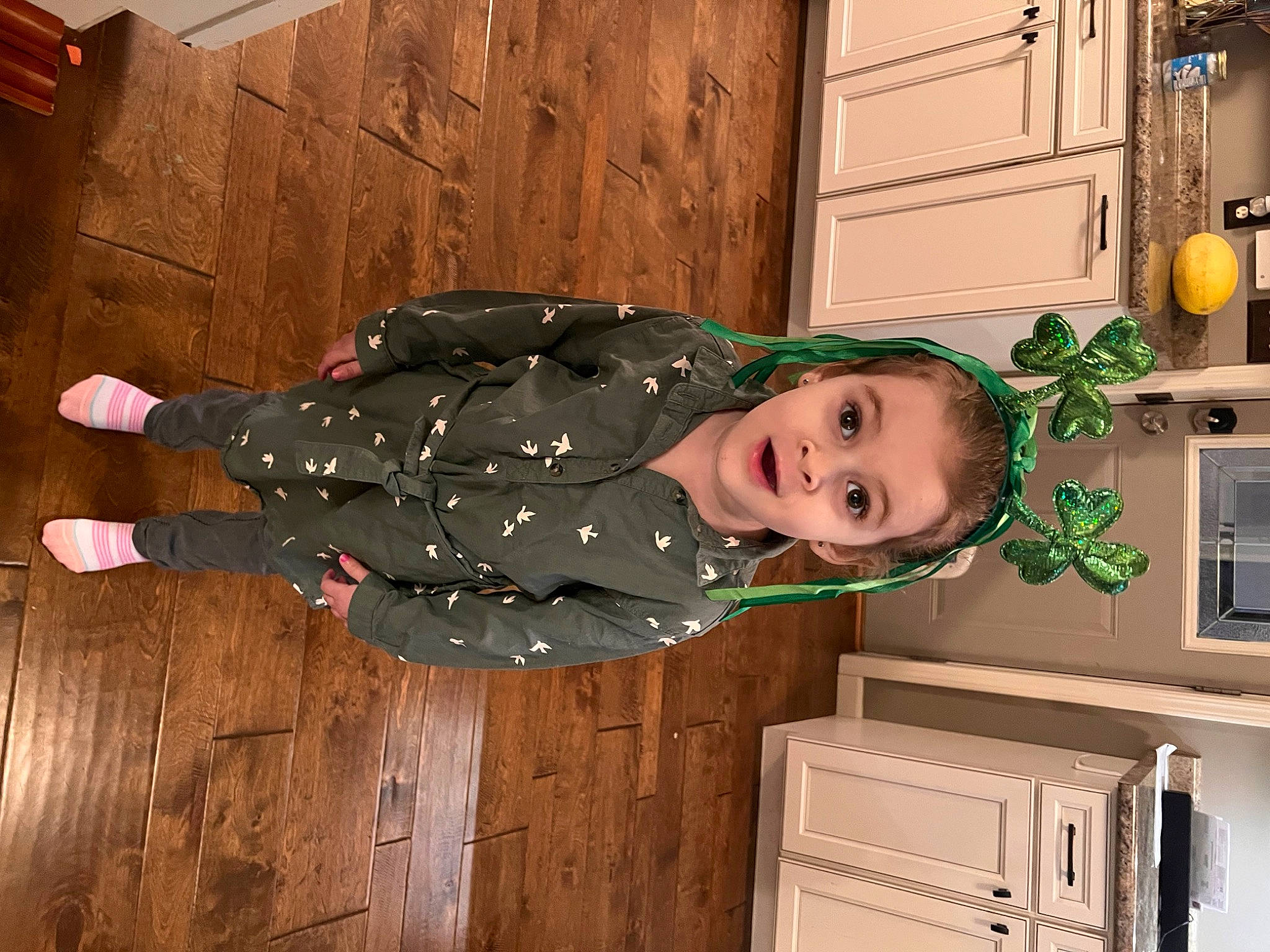 Rory is registered to the contest to win money with this photo: baby_toddler_clothing, cabinetry, child, flooring, fun, hardwood, home_appliance, jacket, kitchen, kitchen_appliance, laundry_room, major_appliance, microwave_oven, person, room, smile, surprise, toddler, varnish, wood