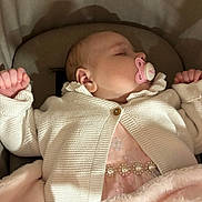 Delilah joined the competition — help win amazing prizes! baby, sleeping, pacifier, white_cardigan, pink_dress, pearls, blanket, infant, cute, cozy, soft, cushion, child, portrait, indoors, resting, peaceful, clothing, newborn, comfort