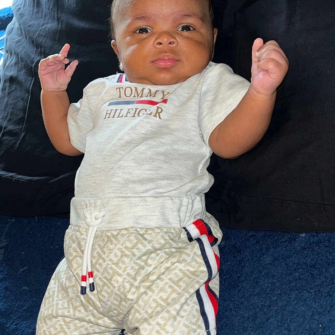 Davion joined the competition — help win amazing prizes! baby, carpet, child, clothing, cute, fashion, furniture, indoor, infant, person, pillow, portrait, raised_hands, relaxing, shirt, shorts, smiling, socks, tommy_hilfiger, young