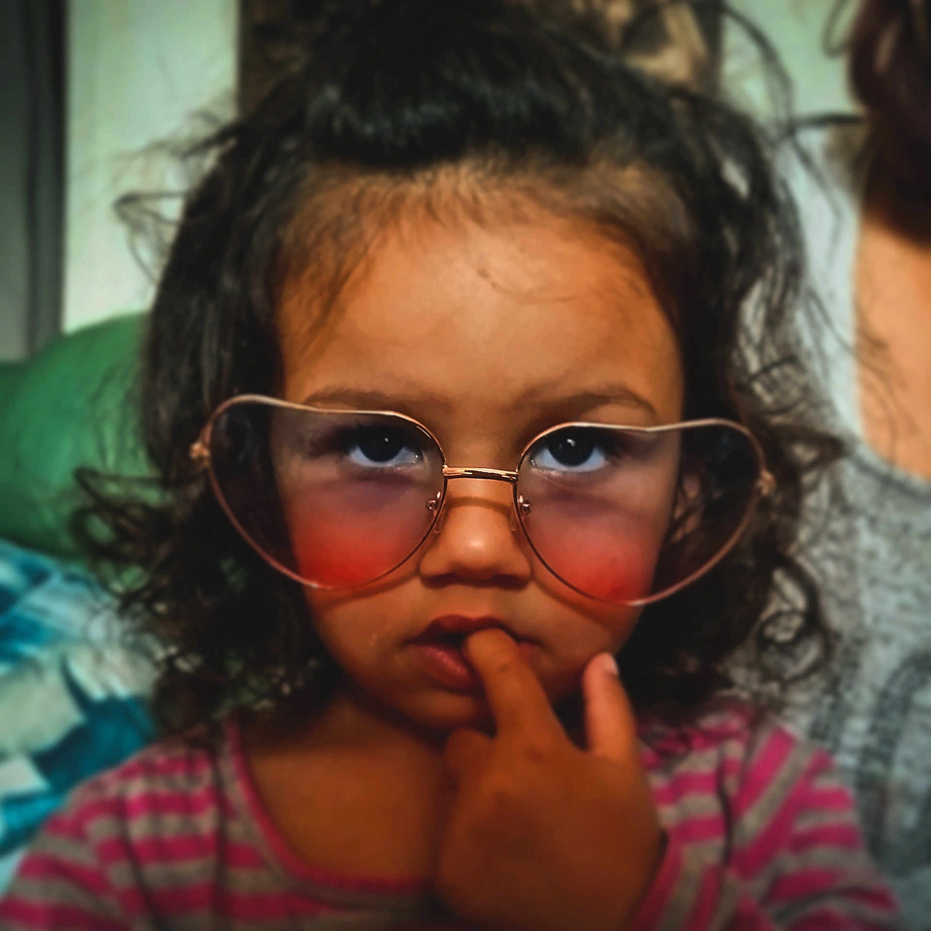Livia participe au concours pour gagner de l'argent avec cette photo : child, curly_hair, glasses, heart_shaped_glasses, finger_in_mouth, thoughtful, portrait, indoor, pink_striped_shirt, close_up, face, person, young, casual, expression, cute, eyewear, fashion, childhood, skin