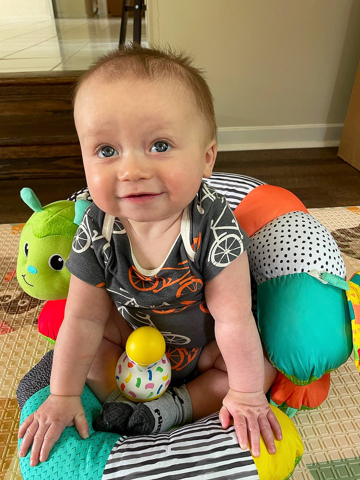 Wyatt is registered to the contest to win money with this photo: arm, baby, baby_toddler_clothing, cheek, eye, facial_expression, finger, flooring, happy, head, human_body, iris, joint, joy, leg, organ, person, product, skin, smile
