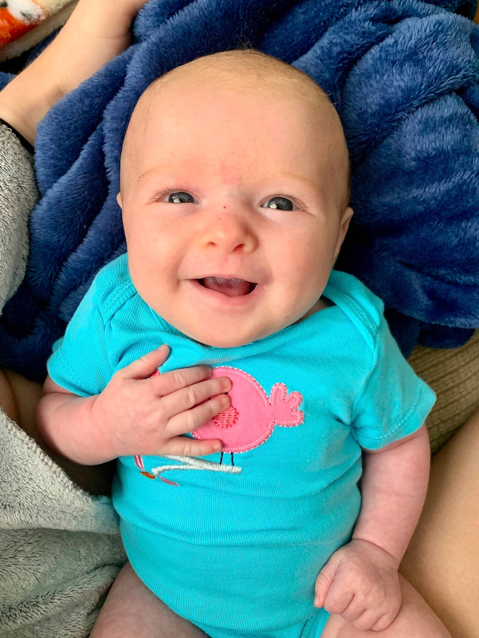 Saige is registered to the contest to win money with this photo: azure, baby, baby_toddler_clothing, blue, cheek, chin, comfort, eye, gesture, happy, head, iris, mouth, nose, person, pink, product, skin, sleeve, smile