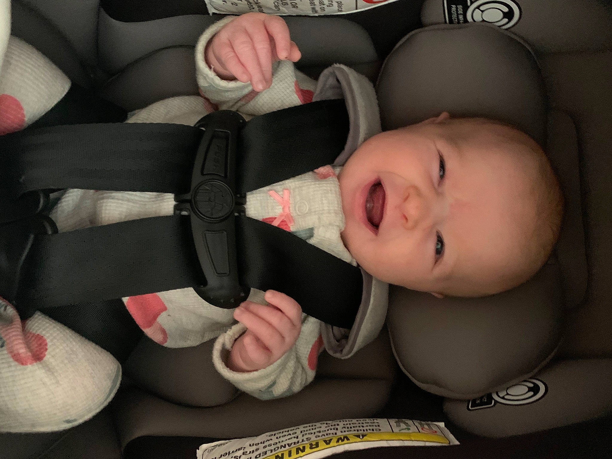 Saige is registered to the contest to win money with this photo: baby, baby_carriage, baby_in_car_seat, baby_toddler_clothing, car_seat, cheek, comfort, eye, face, finger, gesture, hand, head, human_body, mouth, nail, nose, person, skin, thumb