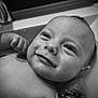 baby, infant, bath, water, smile, face, skin, closeup, expression, child, cute, happy, portrait, wet, person, newborn, black_and_white, innocence, emotion, relaxation