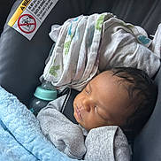 Duraey is registered to the contest to win money with this photo: baby, newborn, sleeping, car_seat, blanket, mittens, bottle, cloth, infant, child, face, portrait, rest, cozy, indoor, cute, peaceful, babycare, soft, toddler