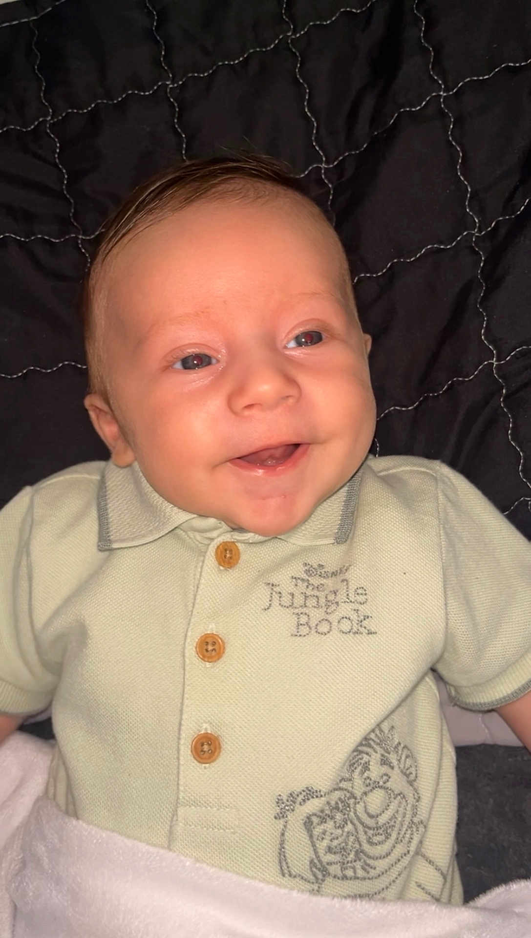 Jordan joined the competition — help win amazing prizes! baby, smiling, infant, clothing, shirt, jungle_book, blanket, quilted, happy, cute, child, portrait, lying_down, indoors, face, head, buttoned_shirt, toddler, young_child, soft_lighting