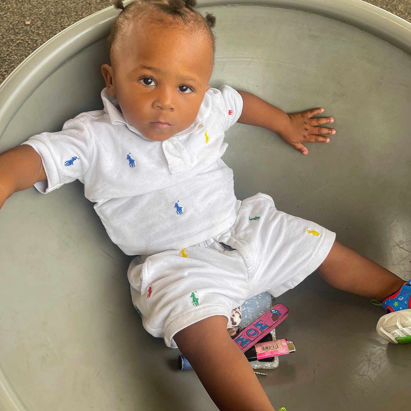 Lamont joined the competition — help win amazing prizes! casual_outfit, child, childrens_fashion, colorful_logos, comfortable, curious_expression, floor, hair_buns, indoor, person, play_area, portrait, round_container, sandals, sitting, skin, small_objects, toddler, white_clothing, young_child