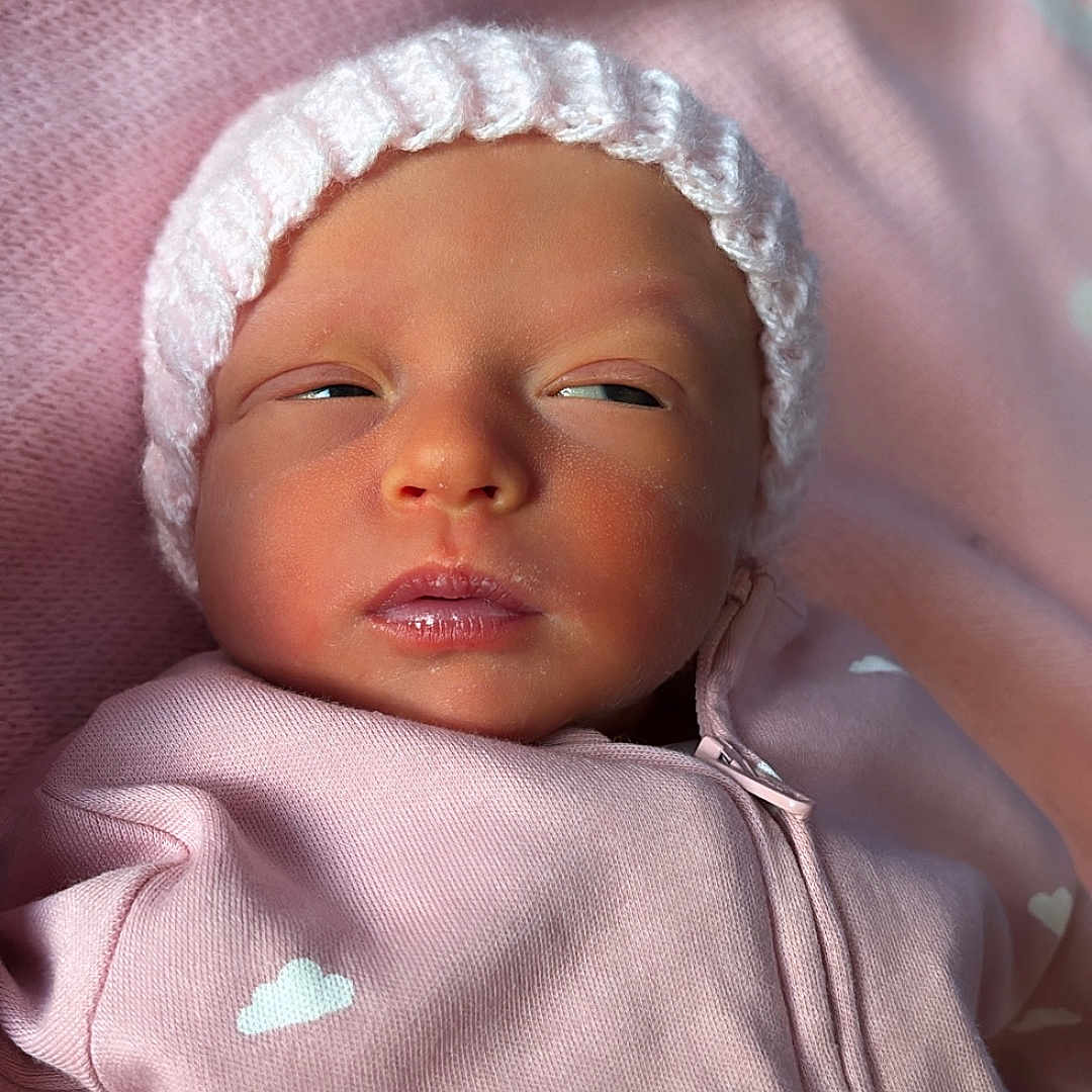 Mabel joined the competition — help win amazing prizes! baby, beanie, bonnet, cap, clothing, face, hat, head, hood, hoodie, knitwear, newborn, person, photography, portrait, sweater, sweatshirt