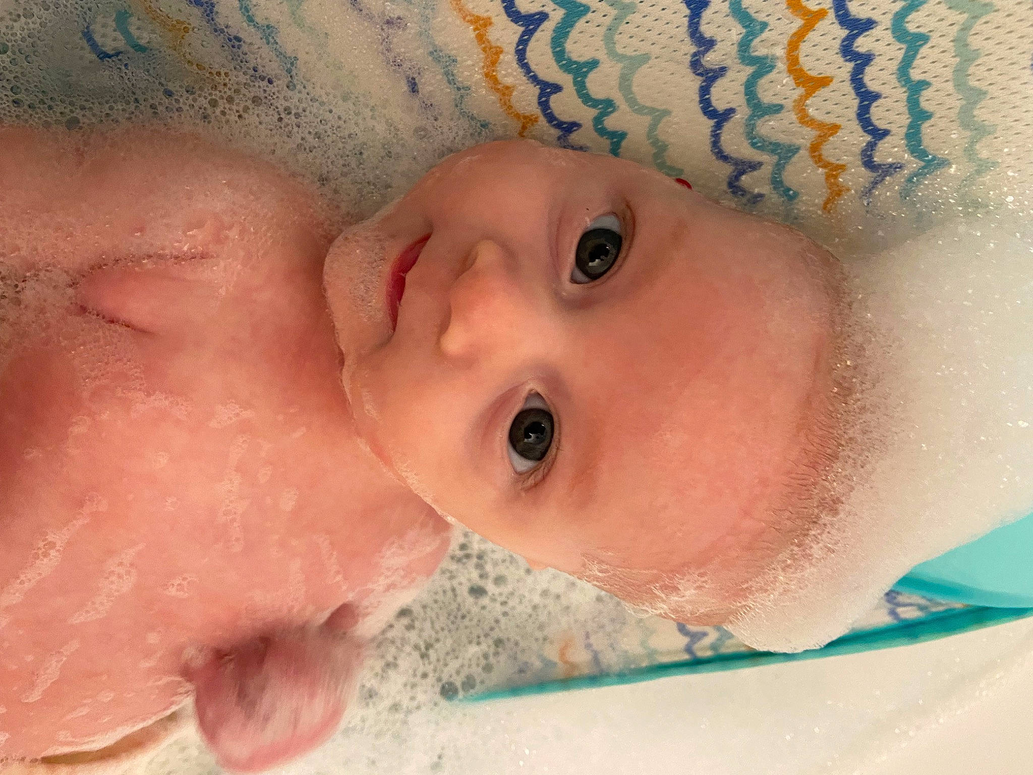 Kolbie joined the competition — help win amazing prizes! baby, baby_bathing, bathing, cheek, chin, eyebrow, eyelash, fluid, foam, happy, headgear, human, iris, lip, mouth, nose, person, pink, skin, textile