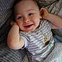 Caleb is registered to the contest to win money with this photo: baby, bed, bedroom, blanket, clothing, cushion, face, furniture, happy, head, homedecor, indoors, laughing, newborn, person, photography, portrait, quilt, smile, t_shirt