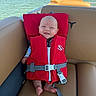 Wrenlee Jade joined the competition — help win amazing prizes! baby, life_jacket, boat, water, lake, outdoor, seat, smile, child, sunlight, nature, recreation, summer, safety, blue_sky, greenery, person, clothing, infant, vacation