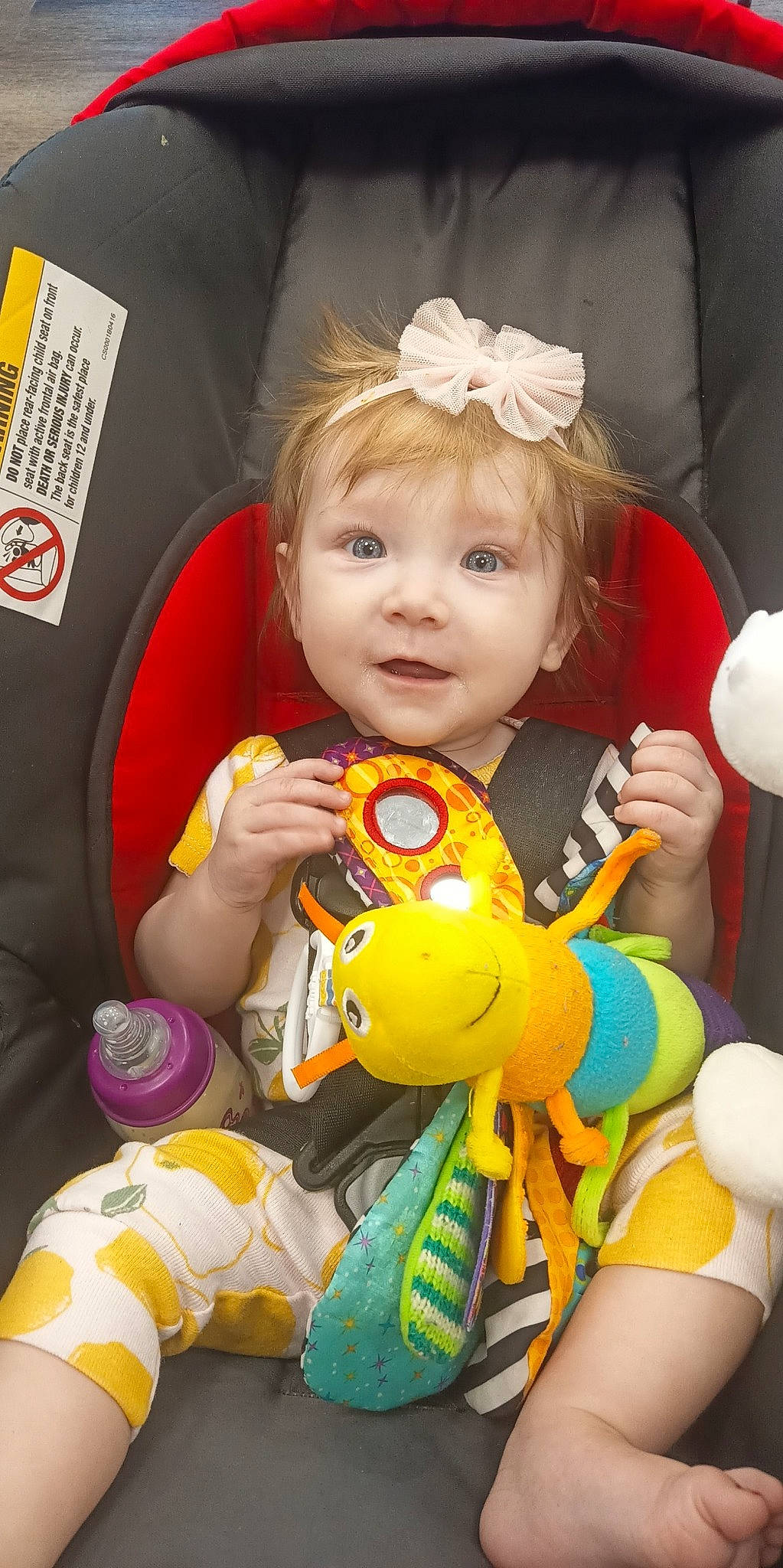 Addyson is registered to the contest to win money with this photo: baby, baby_products, baby_toddler_clothing, cheek, child, eye, face, facial_expression, fun, happy, head, iris, orange, person, product, sitting, skin, smile, toddler, toy