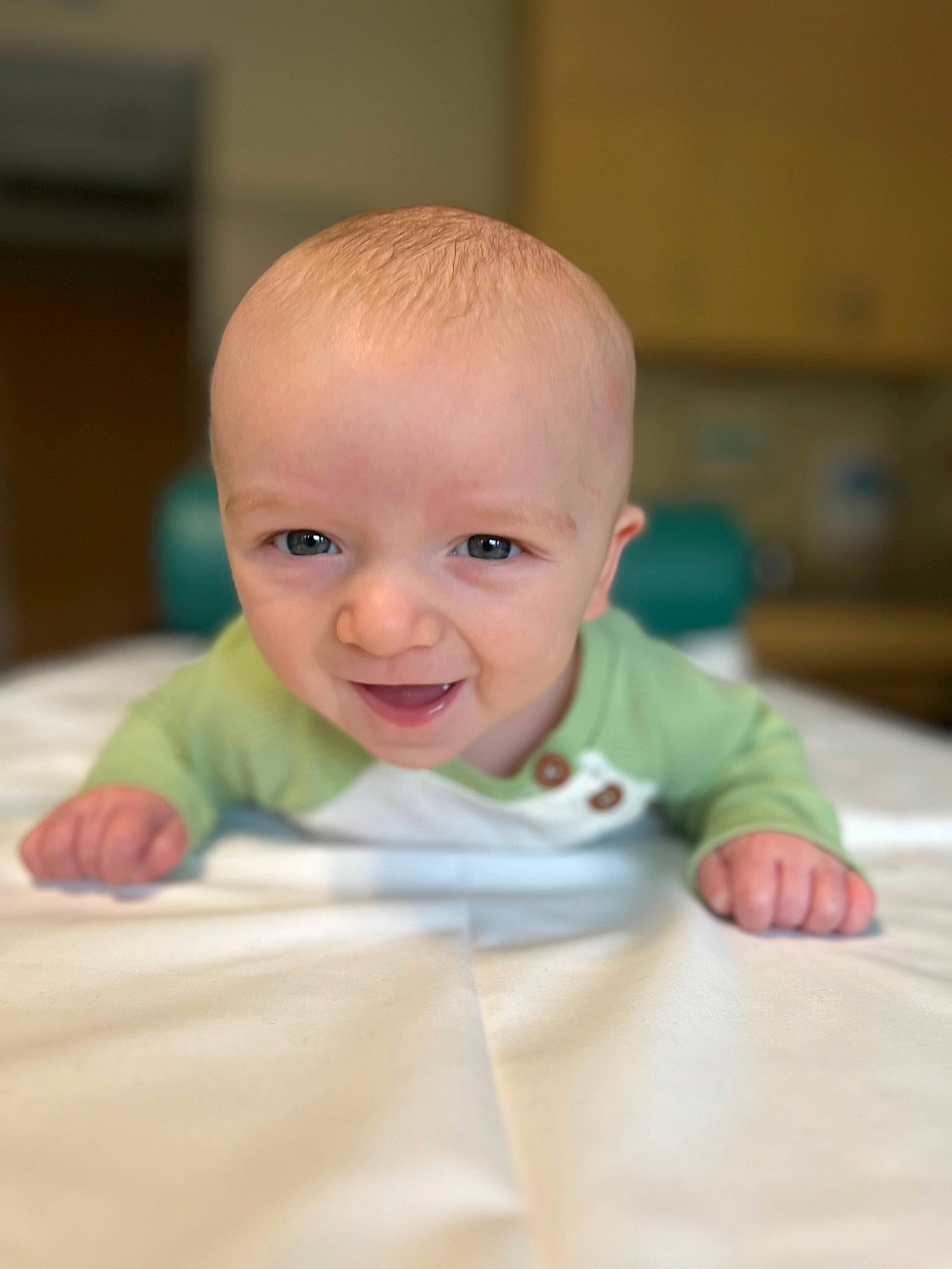 Aris is registered to the contest to win money with this photo: baby, baby_toddler_clothing, cheek, comfort, eye, eyebrow, face, finger, floor, flooring, happy, hardwood, iris, nose, person, skin, sleeve, smile, toddler, tummy_time